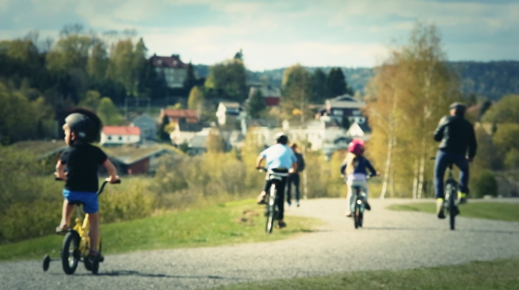 Sykkelfamilie langs flomvollen