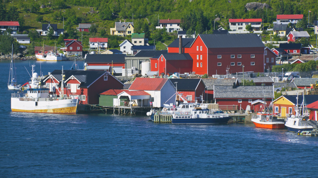 Utsikt over Reine i Lofoten med fiskebåter og hus langs sjøen – et levende lokalsamfunn som symboliserer Venstres mål om sterke lokaldemokratier og gode liv i hele landet, uansett hvor du bor.