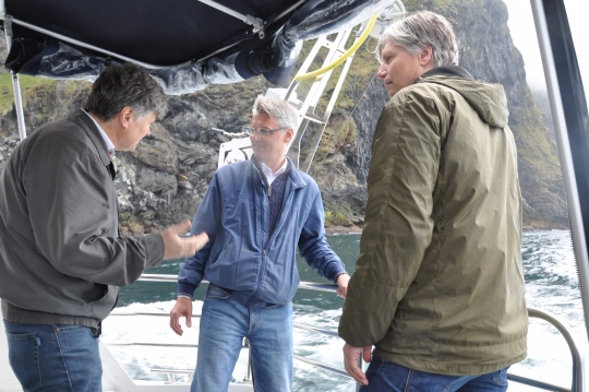  Ola Elvestuen i båt ved fuglefjellet på Runde, flankert av ordfører Arnulf Goksøyr og Nils Roar Hareide